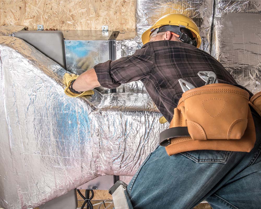 Memphis contractor installing a radiant insulation barrier to help improve AC efficiency.