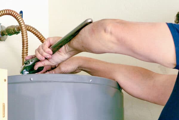 Homeowner repairing a water heater