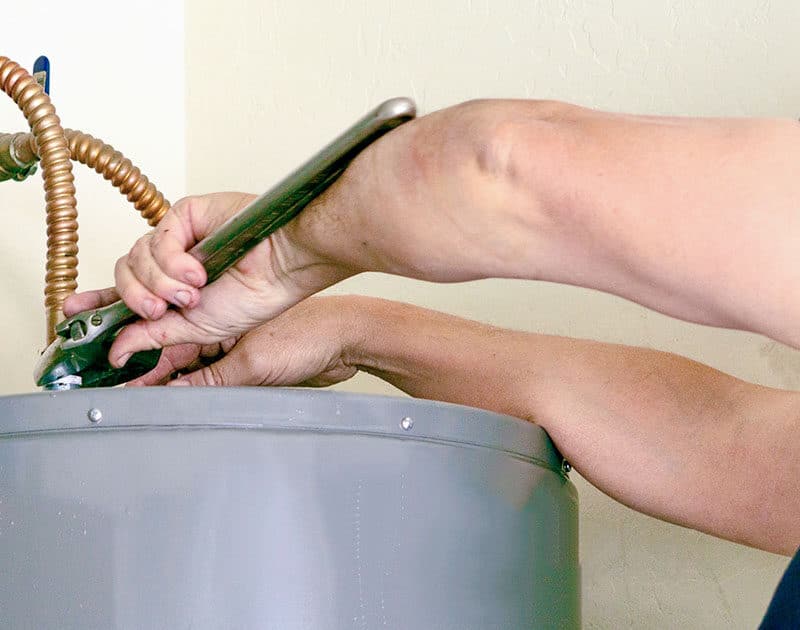 Homeowner repairing a water heater